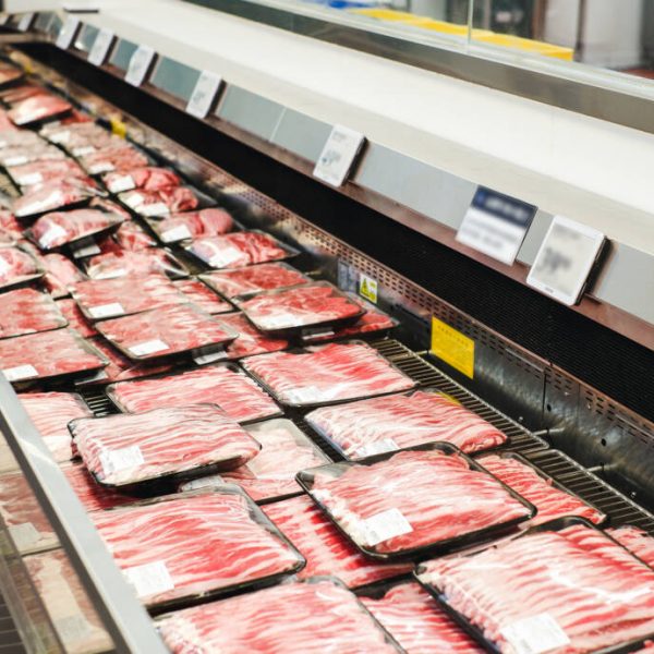 different types of packed meat in the meat cooler