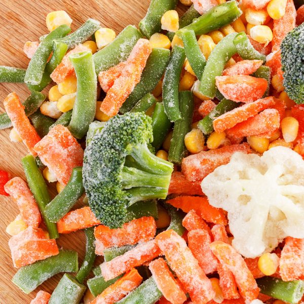 Assorted set of frozen vegetables on cutting board can be used as background